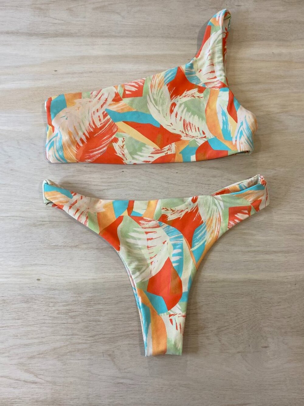 Skatie bathing suit. Matching one strap top and skimpy bottom. Barely worn
